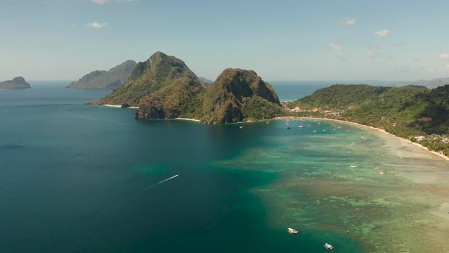 Aerial drone of tropical beach on background of mountains. Corong corong beach, El Nido, Palawan, Philippines.