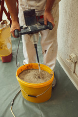Fototapeta premium Worker using machine for plastering.