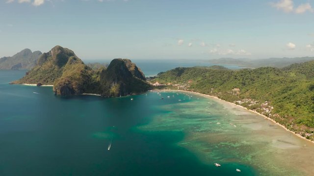 Aerial drone of tropical beach on background of mountains. Corong corong beach, El Nido, Palawan, Philippines.