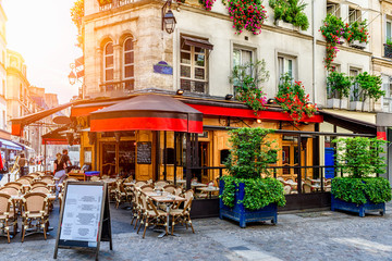 Fototapeta Cozy street with tables of cafe in Paris, France. Architecture and landmark of Paris. Cozy Paris cityscape. obraz