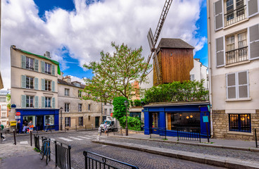 Cozy street with old mill in quarter Montmartre in Paris, France