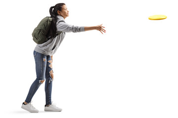Female student throwing a plastic disc