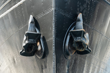 Two anchors on vessel board, steel vintage cargo ship