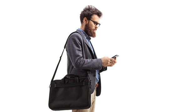 Man with shoulder bag holding a cellphone