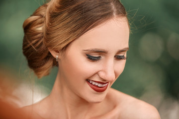 Fototapeta premium portrait of a happy bride on the background of spring foliage