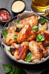 Hot chicken wings and draft beer