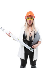 Sexy blonde posing in orange construction helmet, goggles and holding a construction level