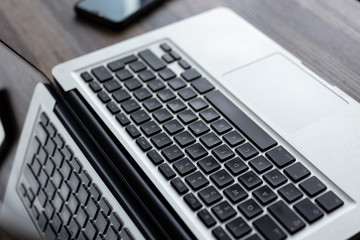 Silver white laptop computer keyboard from above