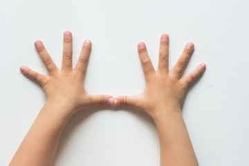 Two hands of child with widespread fingers on the white background
