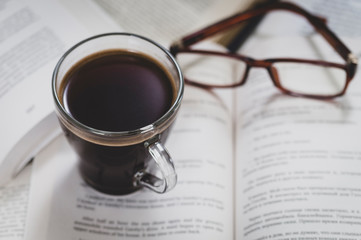 coffee mug glasses and books, toning, selective focusing