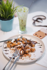 Hong Kong waffle. A leftover food of Hong Kong bubble waffles with chocolate sauce and marshmellow, soft focus.
