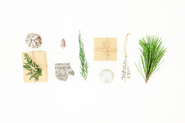Christmas winter composition with gifts, decorations, branches and pine cone on white background. Flat lay