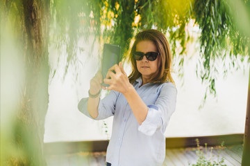 Fototapeta premium Woman making selfie outdoors