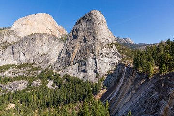 Daytime view of Half Dome, Liberty Cap and Nevada Falls in Yosemite National Park, Californa on a sunny September day in 2019.