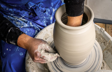Master class on modeling of clay on a potter's wheel In the pottery workshop