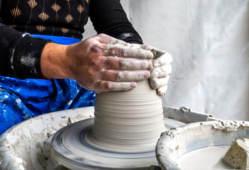 Master class on modeling of clay on a potter's wheel In the pottery workshop