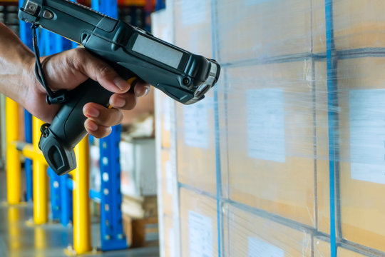 Workers Scanning Bar Code Scanner on Package Boxes. Shipping Warehouse. Computer Mobile Work Tools for Inventory Management. Shipping Storehouse.