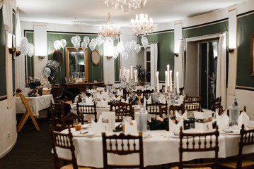 Beautiful decorations of wedding table. Interior of luxury restaurant in vintage aristocratic style. Cozy romantic atmosphere