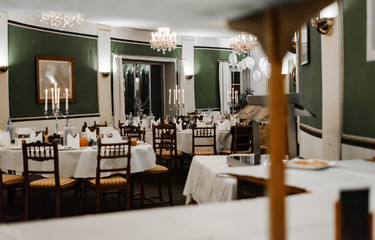 Beautiful decorations of wedding table. Interior of luxury restaurant in vintage aristocratic style. Cozy romantic atmosphere