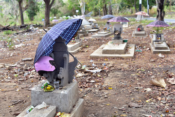 Umbrellas over graves and coffins at Nusa Lembongan cemetery, Indonesia