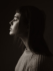 Portrait of young woman. Profile. Sepia.