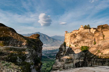 Mysterious monasteries hanging over the rocks of Meteora. Beautiful view of the Varlaam Monastery, located on the edge of a high cliff. UNESCO heritage list object. Amazing Greece landscape.