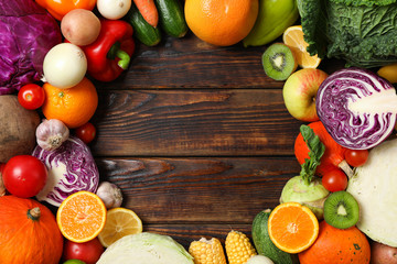 Different vegetables and fruits on wooden background, copy space