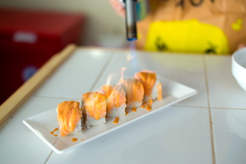 Woman cooking Sushi in the restaurant kitchen. Classic Japanese sushi