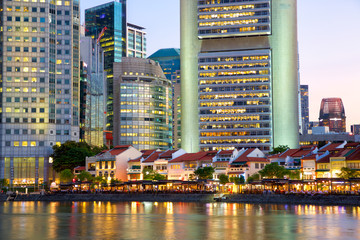 Fototapeta na wymiar Historical district Boat Quay and modern skyscrapers at dusk in Singapore