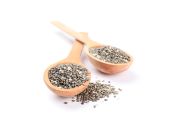 Chia seeds and wooden spoons isolated on white background