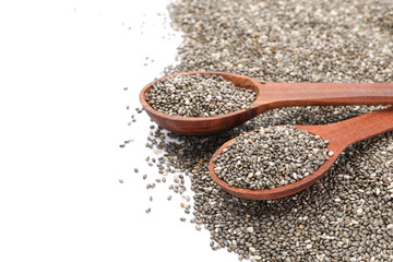 Chia seeds and wooden spoons isolated on white background