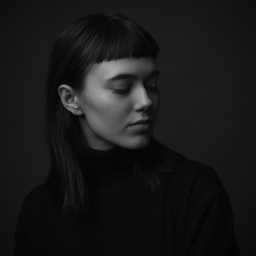 Portrait of sad young woman. Low key. Black and white