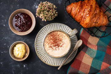cappuccino coffee with croissant on the table, breakfast concept, top view