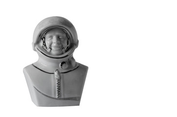 Obraz na płótnie Canvas White ceramic statuette in the shape of an astronaut. Portrait of the first man in space Yuri Gagarin.