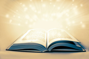White magical light over an old vintage colorized book with copy 