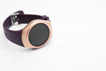 Modern smart watch with on white wooden background. Space for text