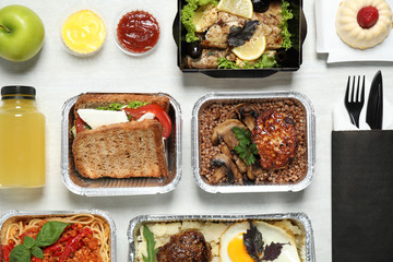 Lunchboxes on white wooden table, flat lay. Healthy food delivery