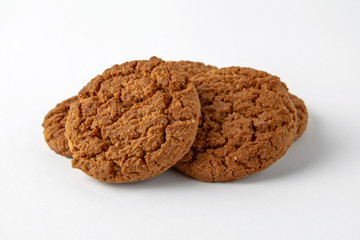 Tasty crunchy cookie: oatmeal, shortbread, chocolate, nutty, honey. Close-up isolated on a white background