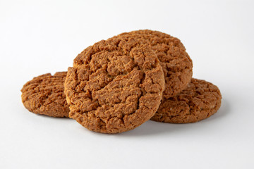 Tasty crunchy cookie: oatmeal, shortbread, chocolate, nutty, honey. Close-up isolated on a white background