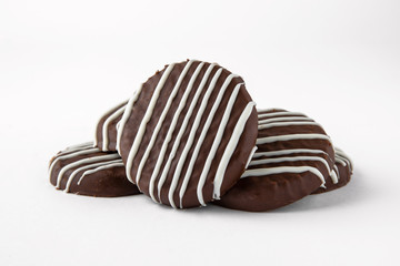 Tasty crunchy cookie: oatmeal, shortbread, chocolate, nutty, honey. Close-up isolated on a white background