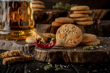 Snack for beer, alcohol. Crispy and crumbly delicious Salty and spicy cookies with seeds, chili peppers, spices and salt. Stylish still life for poster.