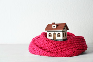 House model and scarf table against white background. Heating efficiency