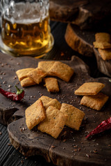Snack for beer, alcohol. Crispy and crumbly delicious Salty and spicy cookies with seeds, chili peppers, spices and salt. Stylish still life for poster.