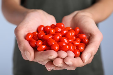 Woman holding fresh goji berries, closeup view