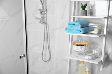 Shelving unit with cotton balls, swabs and pads in bathroom