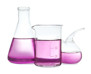 Laboratory glassware with purple liquid on white background