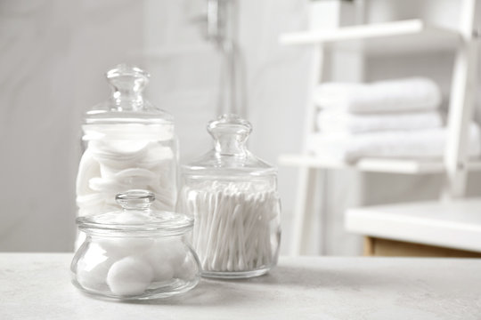 Cotton Balls, Swabs And Pads On Light Grey Table In Bathroom