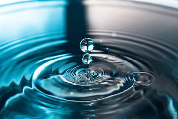 Water splash or drop. Water splash close-up. Blue water drop. Falling water