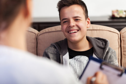 Young teenager boy at counseling not taking it seriously