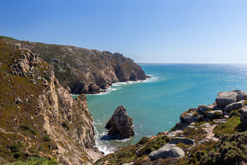 Scenic view of Atlantic Ocean and rugged coast at Cabo da Roca, the westernmost point of continental Europe, in Portugal, on a sunny day.